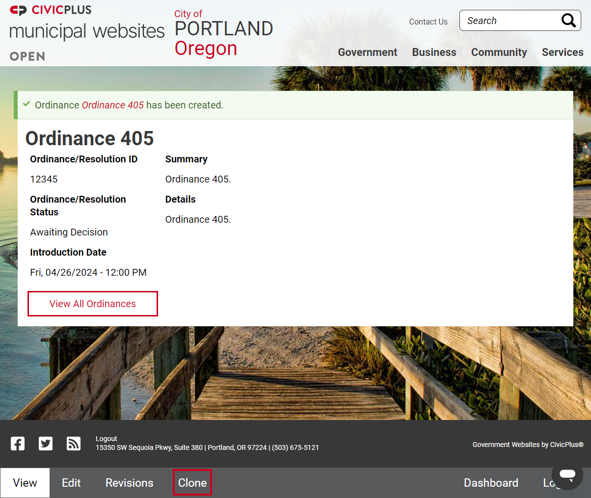 The Clone button in the bottom left corner of the page, to the right of the View, Edit, and Revisions buttons.